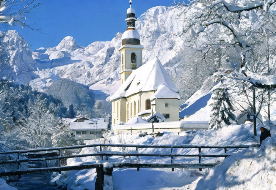 White Church with Black Roof Surrounded by Snow-Covered Trees