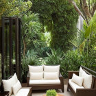 Modern Outdoor Patio with Greenery and Curious Dog