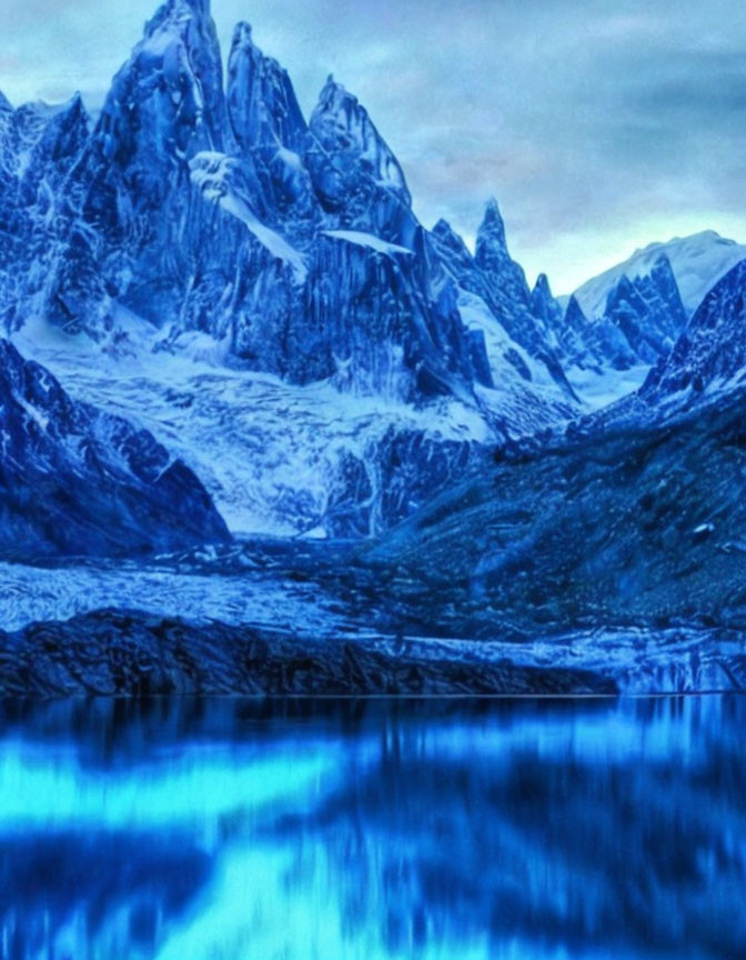 Tranquil blue landscape with lake and snow-capped mountains