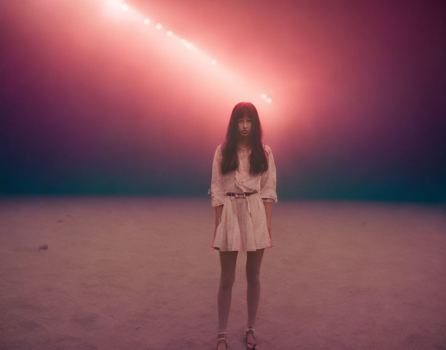 Woman in hazy room with pink and purple lighting