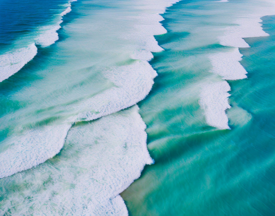 Turquoise Ocean Waters with White Waves on Shore