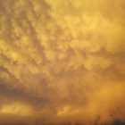 Vibrant golden sunset clouds over desert landscape