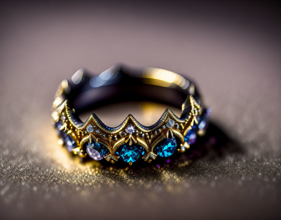 Intricate Gold-Tone Ring with Sapphire-Like Stones