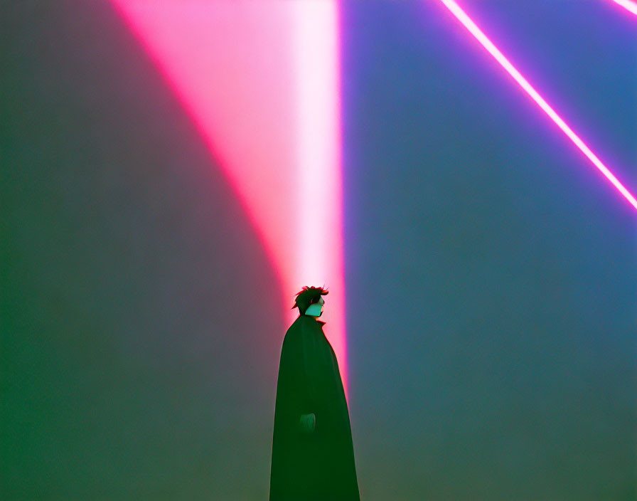 Person's Silhouette Backlit by Colorful Neon Beams