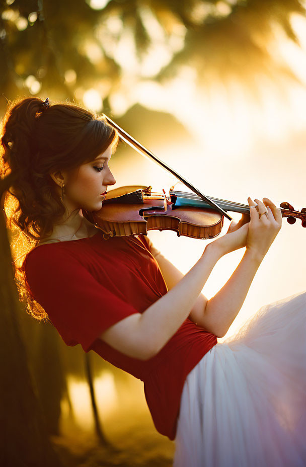 Woman playing violin in sunlit forest with serene expression