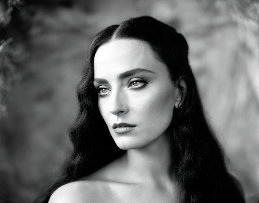 Monochrome portrait of woman with dark hair and striking eye makeup