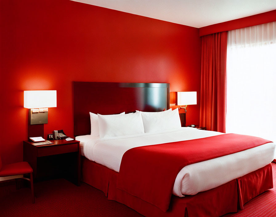 Modern Hotel Room with Large Bed, White Linens, Red Decor, Lamps, and Closed Curt