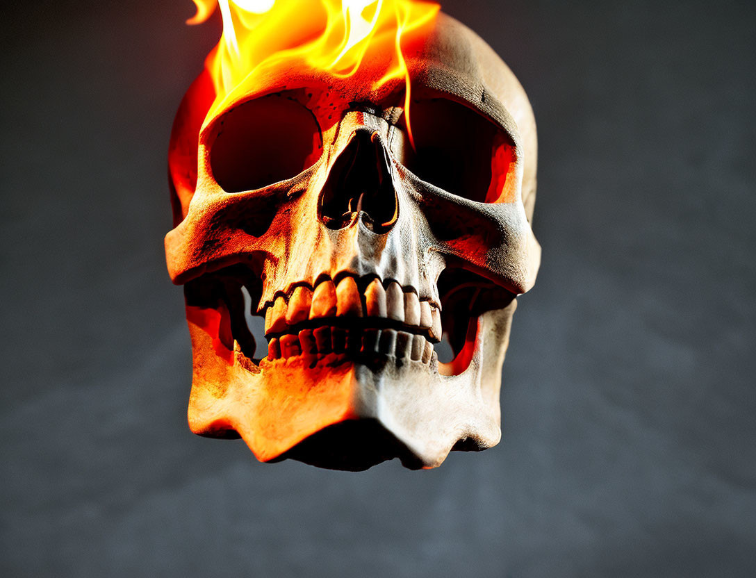 Flaming human skull on dark gray backdrop