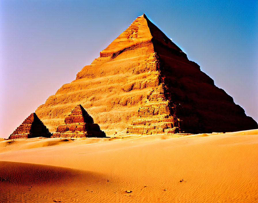 Ancient Egyptian pyramids against desert and sky landscape