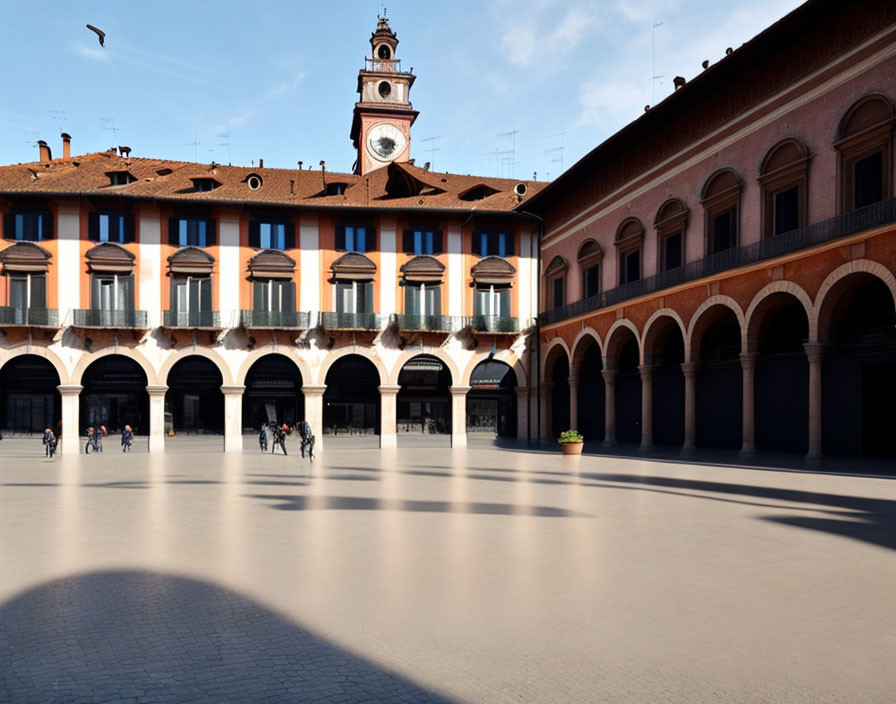 Courtyard with arches, clock tower, and shadow patterns.