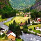 Scenic green valley with river, houses, cliffs, and forests