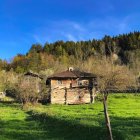 Fantastical landscape with character in armor and wooden houses under clear sky