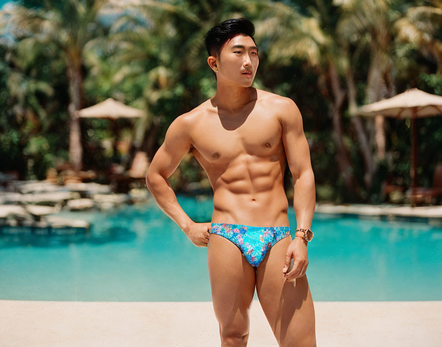 Man in Patterned Swim Briefs by Pool Surrounded by Greenery