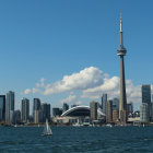 Futuristic cityscape with towering structures and flying vehicles against blue sky