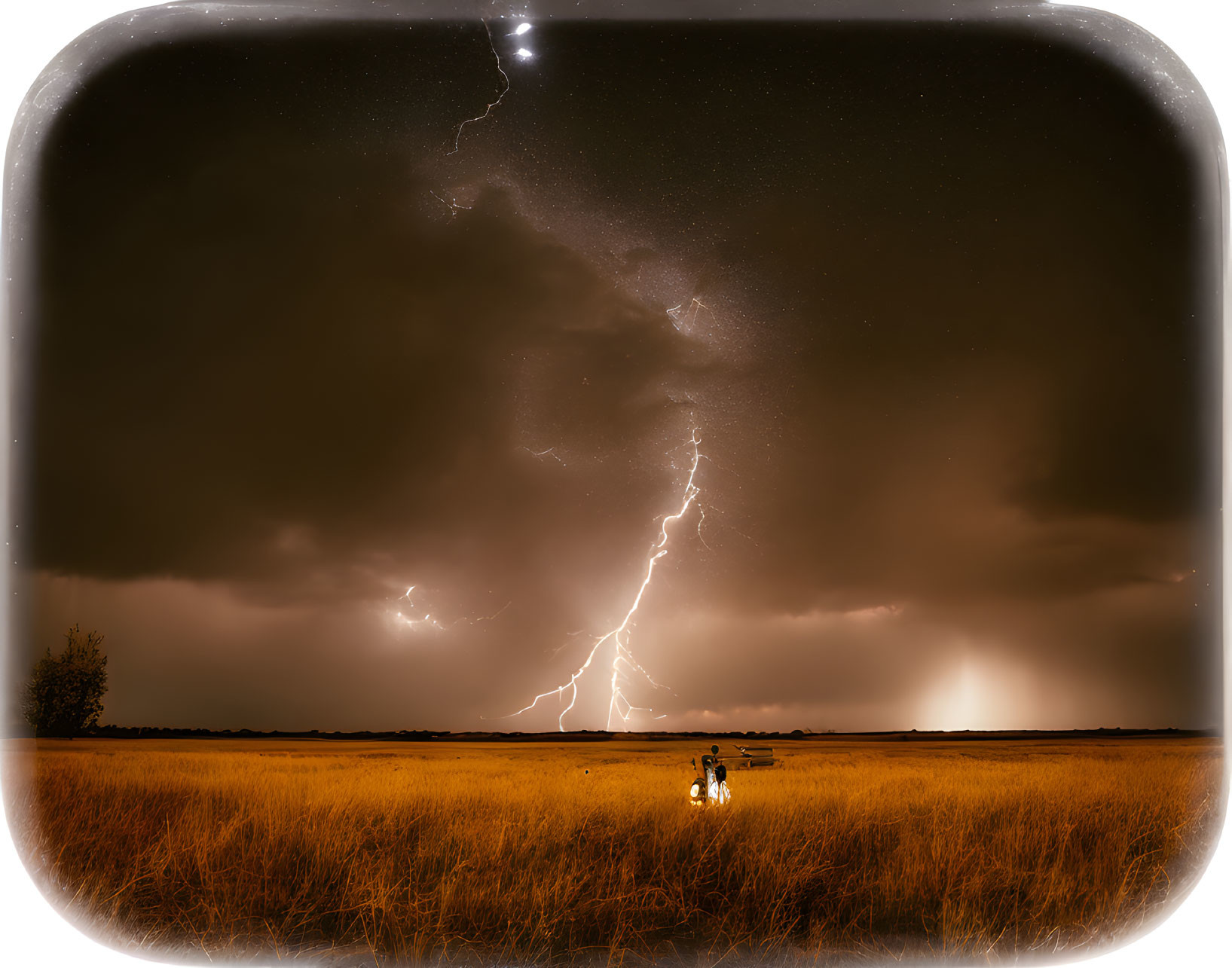 Dramatic lightning strike observed by two people in a field