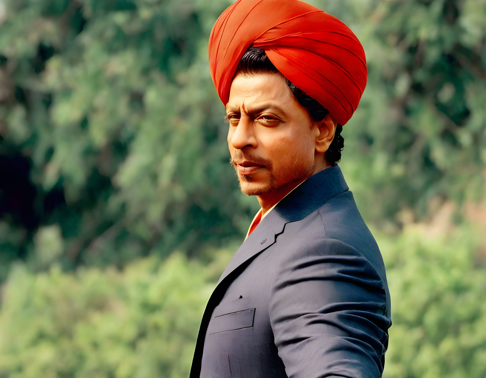 Serious man in red turban and navy blue suit outdoors