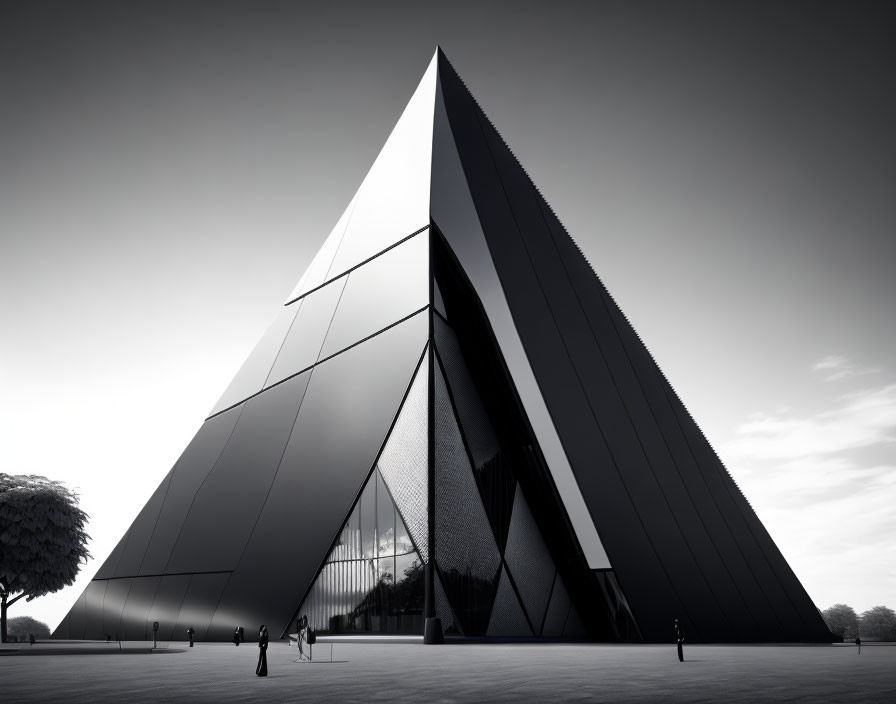 Sharp triangular modern building with reflective black façade panels under a cloudy sky.