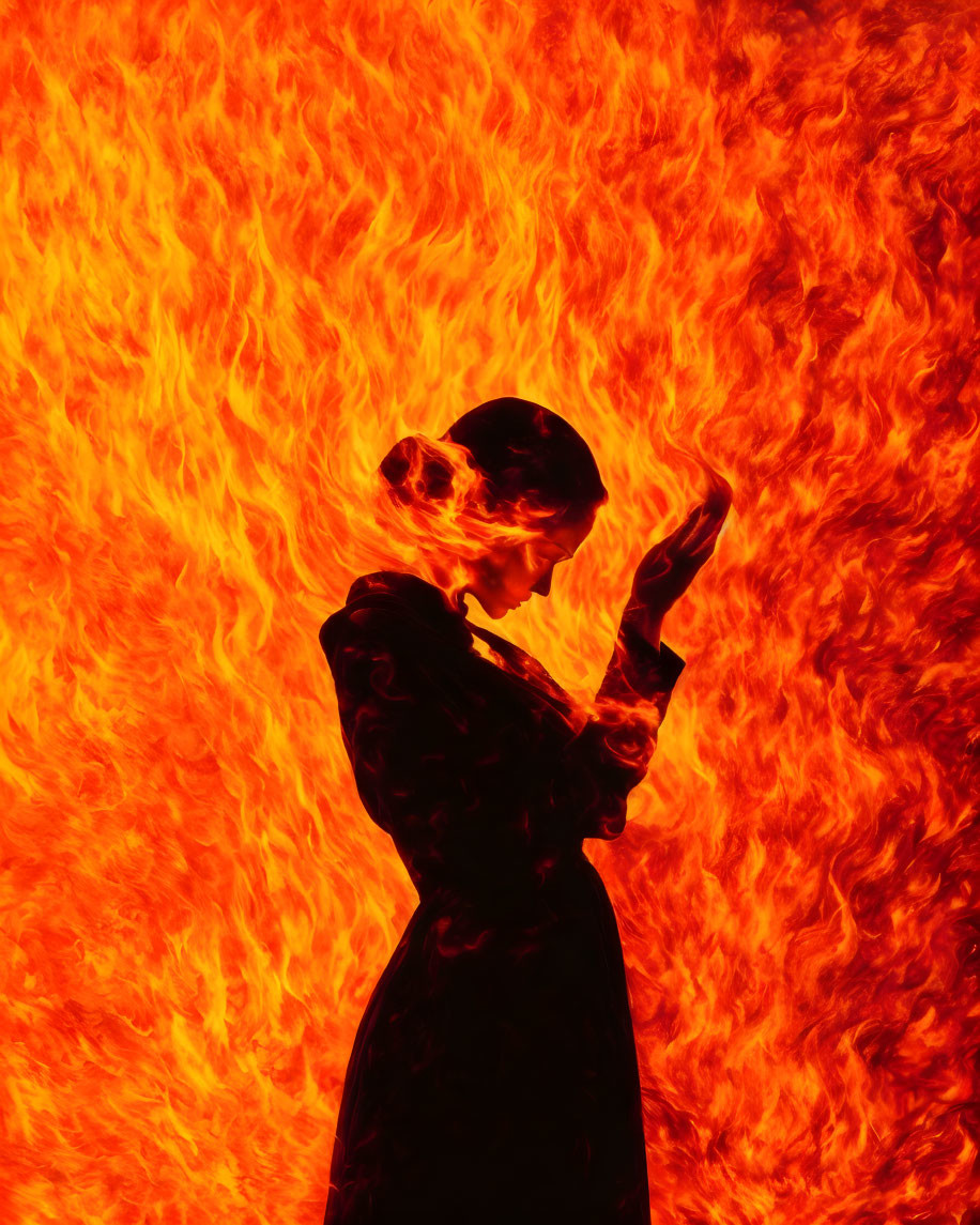 Person silhouette engulfed in vivid orange flames