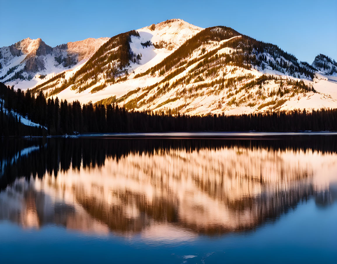 Sunrise Reflection: Snowy Mountains & Tranquil Lake