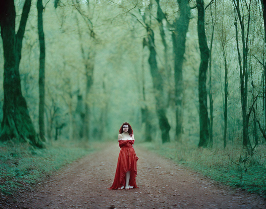 Woman in Red Dress and Glasses Reading Book on Wooded Path