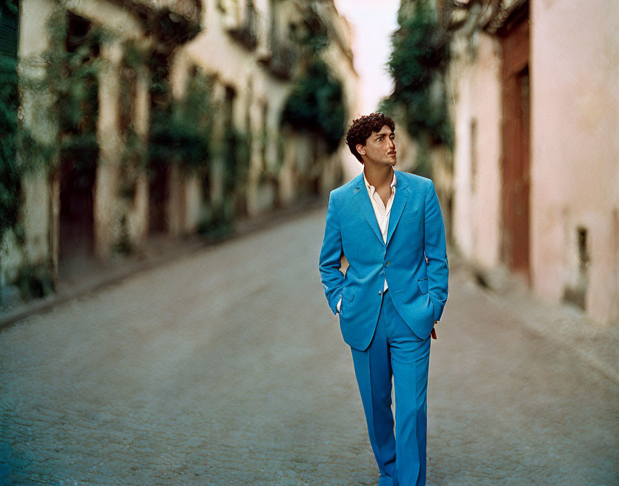 Man in Blue Suit Contemplating in Quaint Alleyway