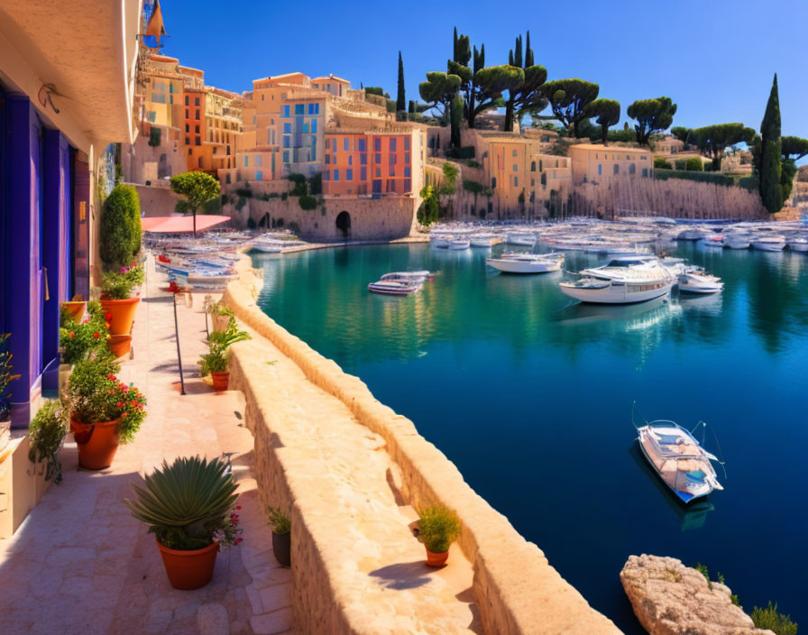 Scenic coastal landscape with blue sea, boats, colorful buildings, and greenery