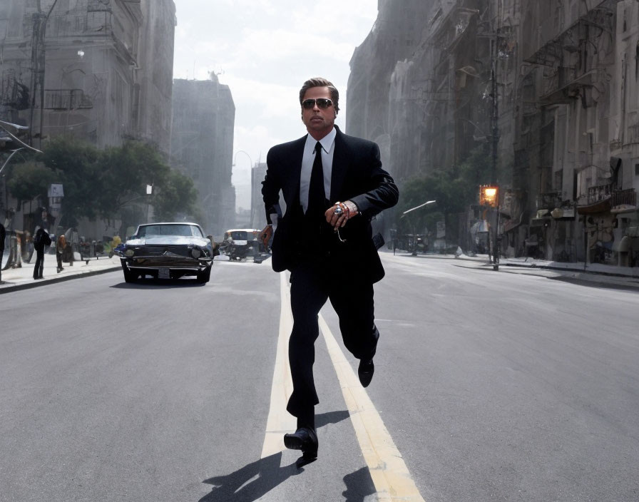 Man in suit and sunglasses running on empty city street with buildings and vintage car.