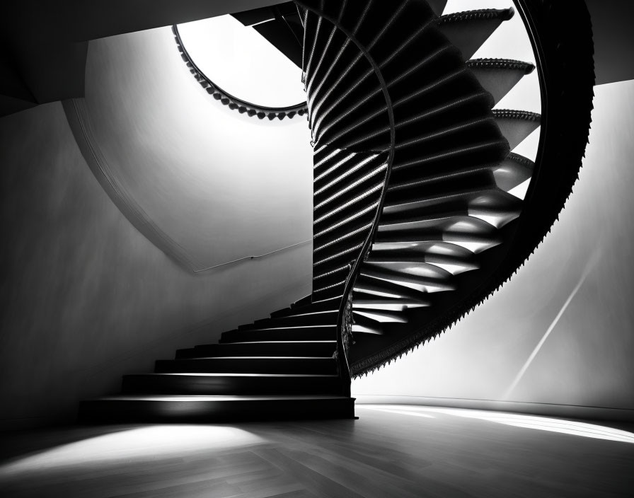 Modern spiral staircase in monochrome with strong lights and shadows