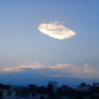 Lenticular Cloud Over Forested Mountains at Twilight