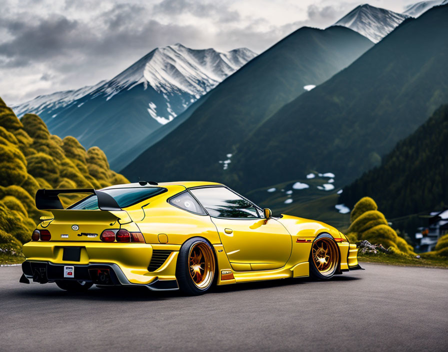 Yellow sports car with large rear wing and golden rims on mountain road