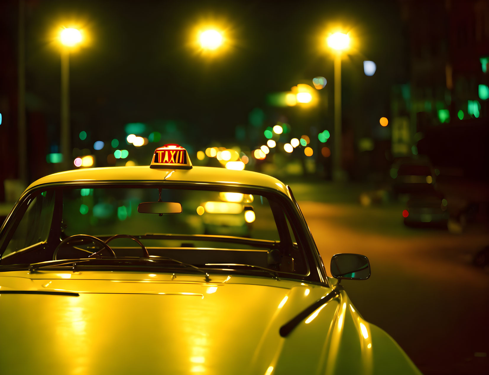 Yellow taxi with lit sign parked at night on illuminated street with bokeh lights.