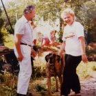 Elderly Couple, Toddler, Dogs, and Lush Garden Path