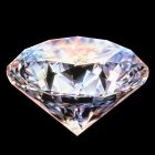 Radiant diamond with multiple facets reflecting light on dark background