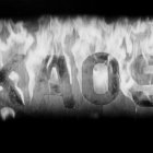 Monochrome image of house in thick smoke with flames.