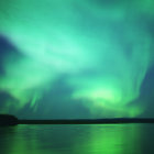 Northern Lights Over Dark Landscape with Water Reflections