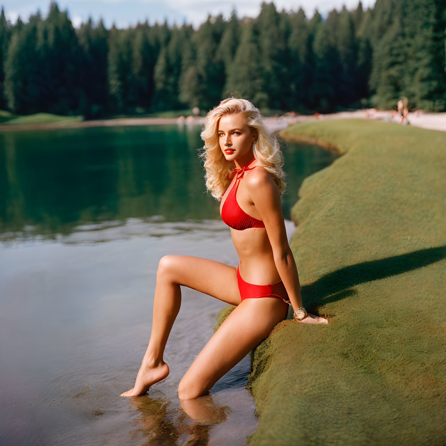 Woman in Red Bikini Poses by Serene Lake in Forest Setting