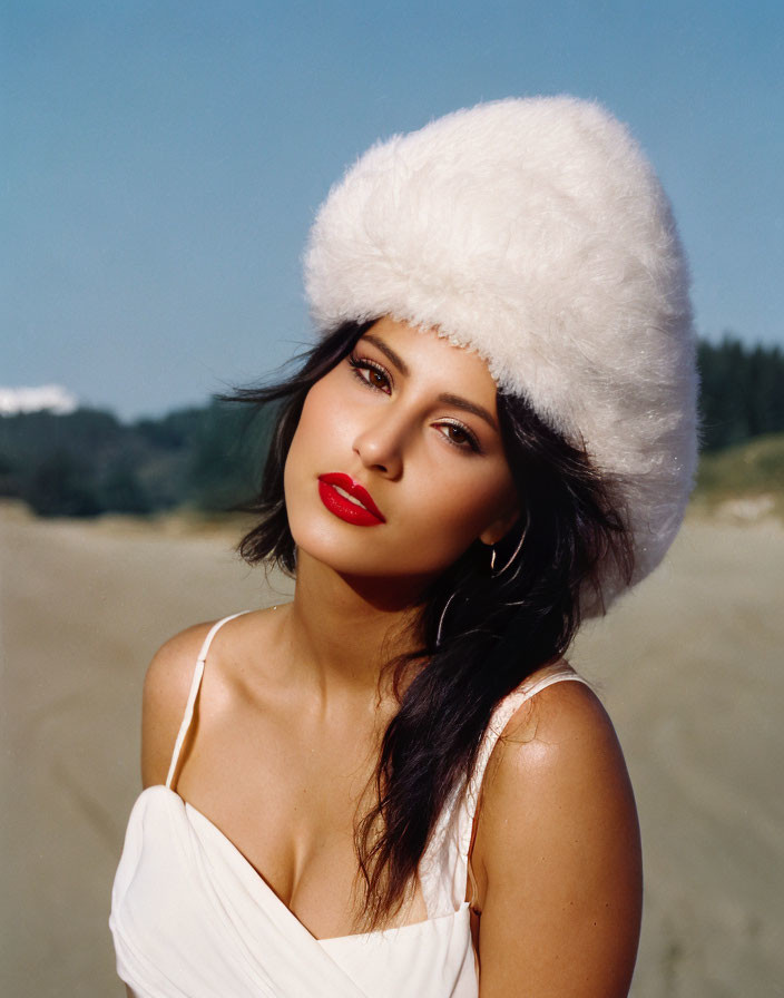 Woman with Red Lipstick and White Fluffy Hat on Sandy Beach