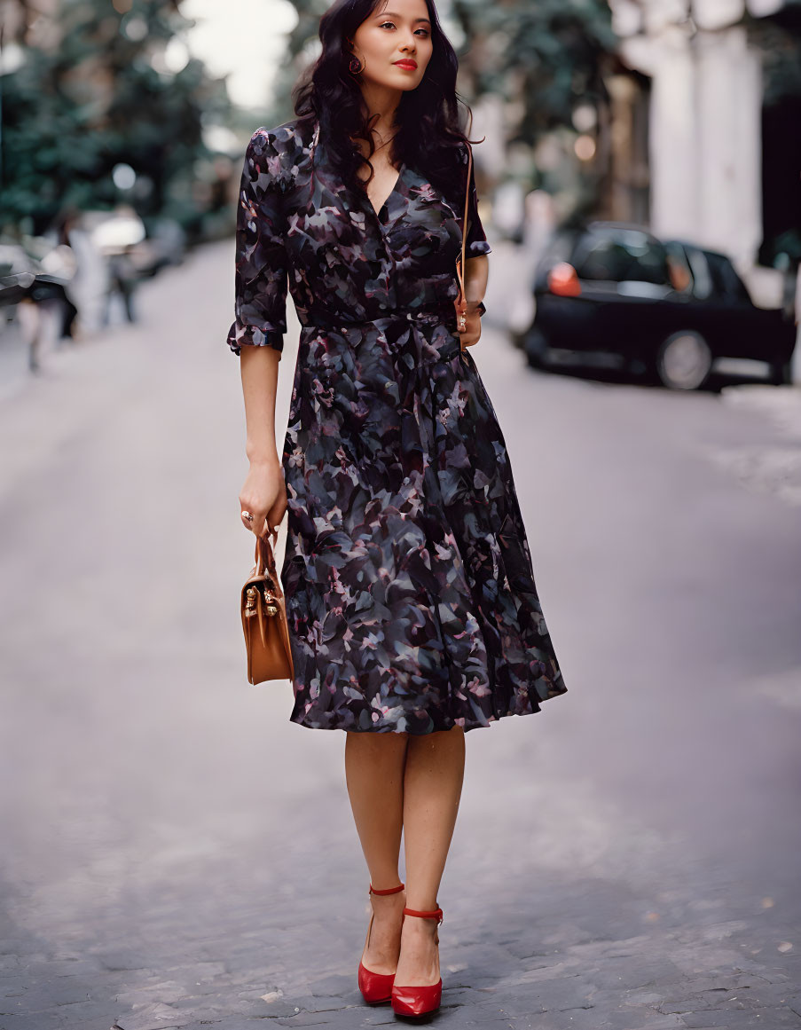 Stylish woman in camouflage dress and red heels on city street