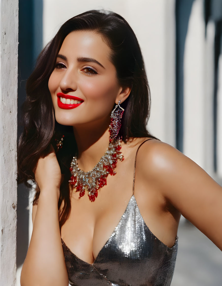 Woman in Red Lipstick and Sparkling Silver Dress with Statement Jewelry Smiling