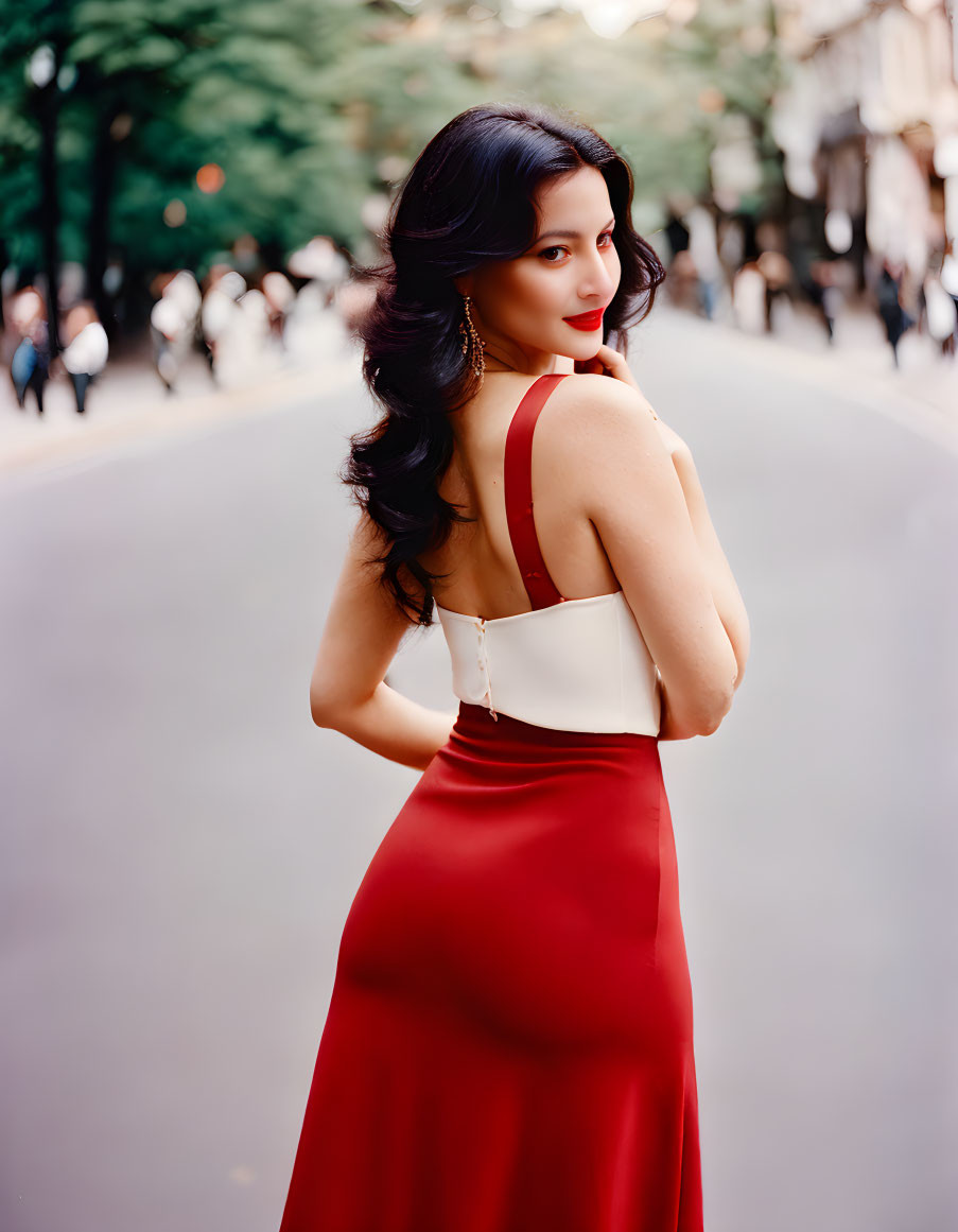 Woman in Red Skirt and White Top on City Street with Crowd