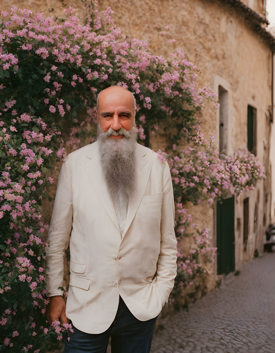 Bearded Man in Beige Suit Against Pink Flower Wall