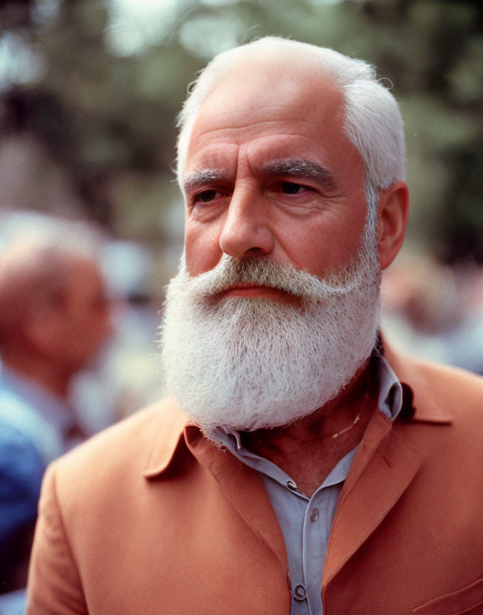 Elderly Man with White Beard in Brown Jacket Outdoors