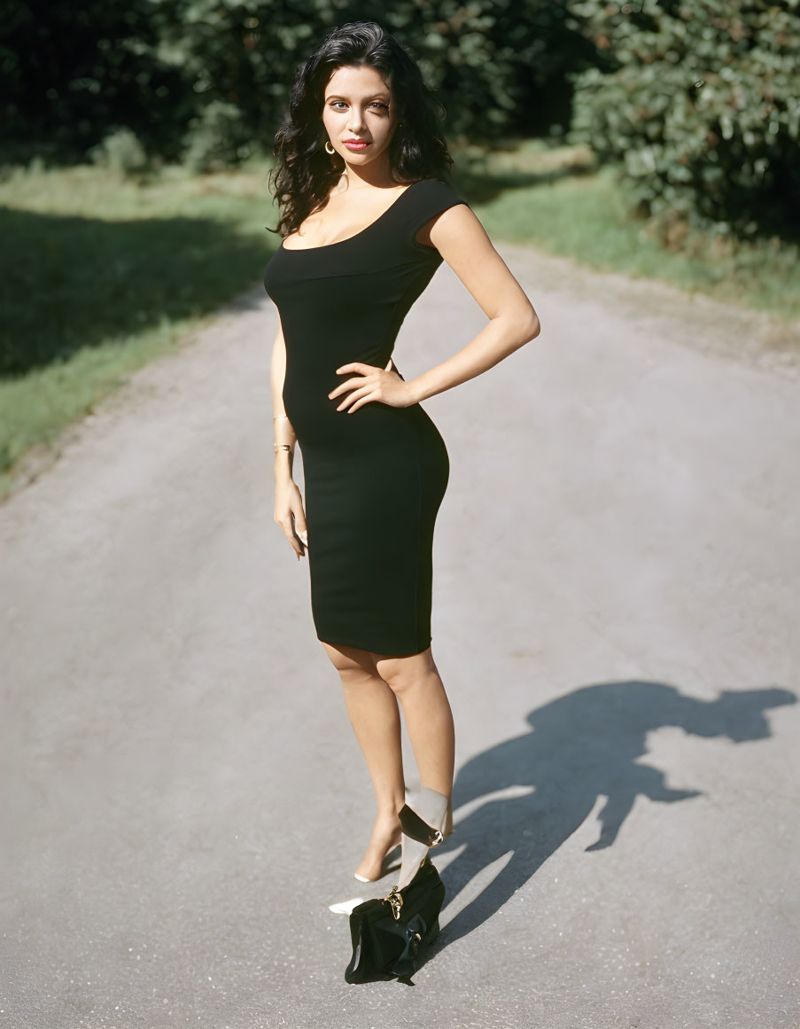 Confident Woman in Off-Shoulder Black Dress Outdoors