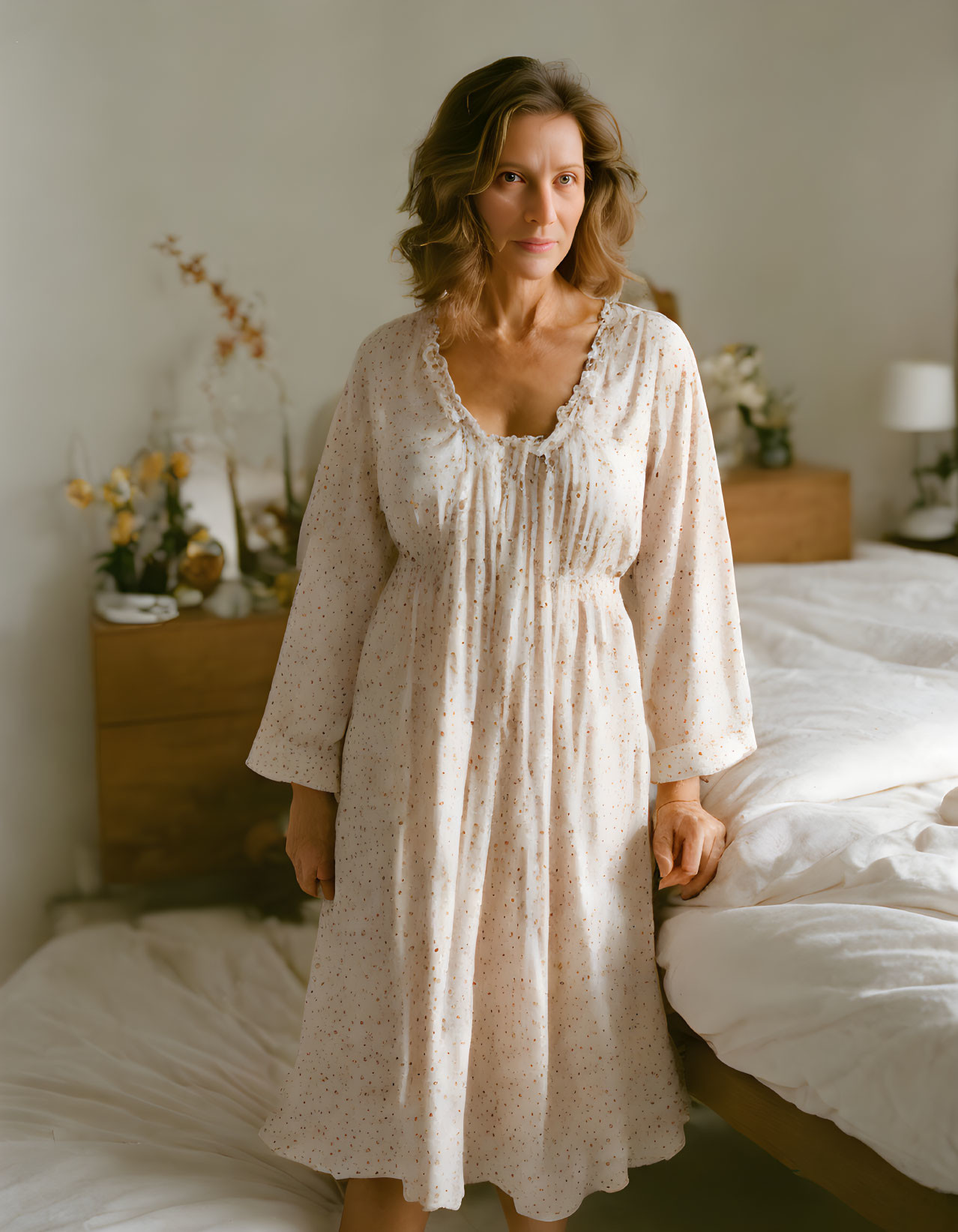 Woman in Polka-Dotted Dress Contemplating by Bed