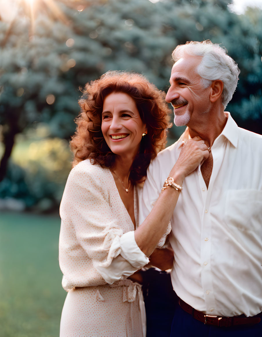 Elderly couple embracing in sunlit garden