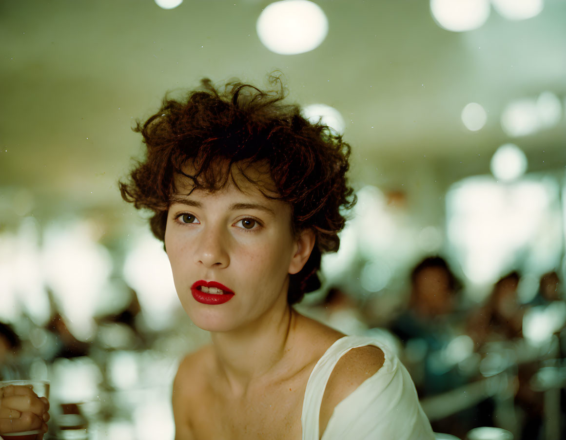 Curly Haired Woman with Red Lipstick in Cafe Scene