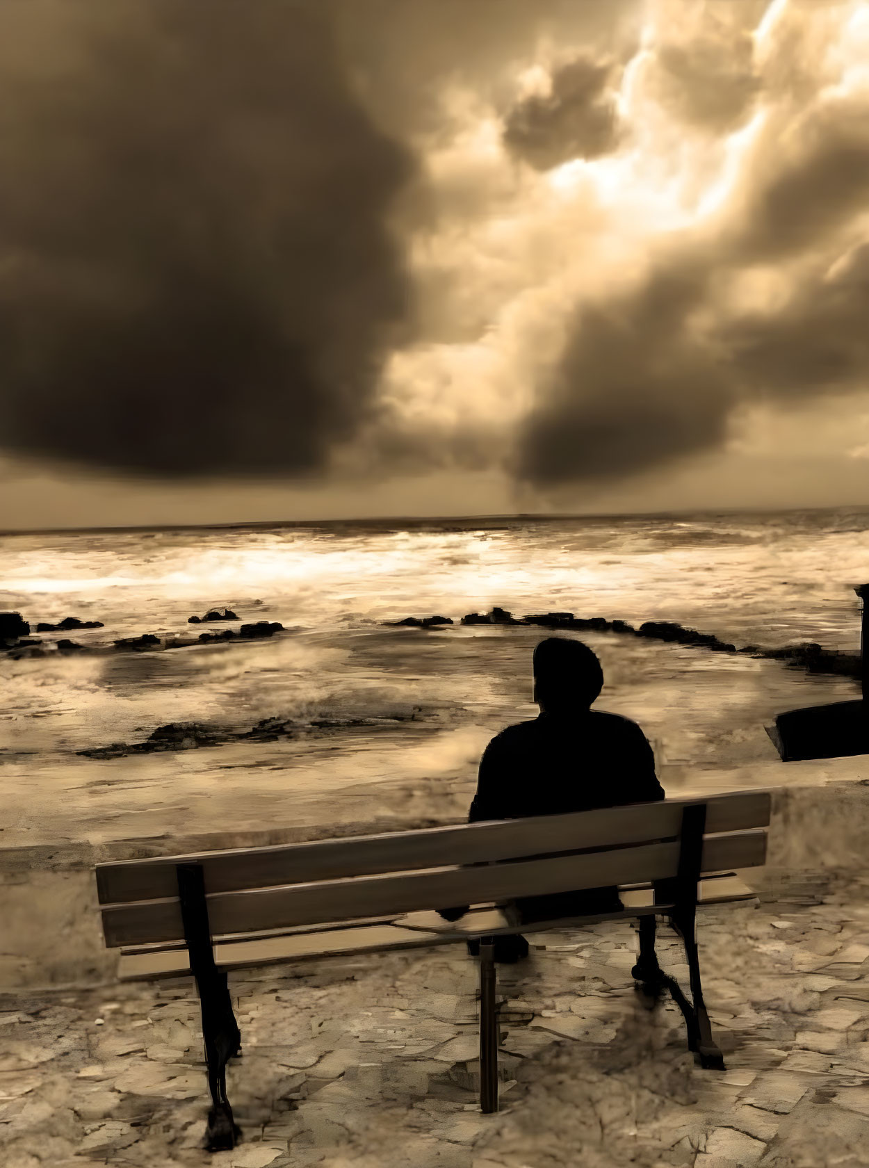 Silhouette of person on bench by stormy sea at sunset