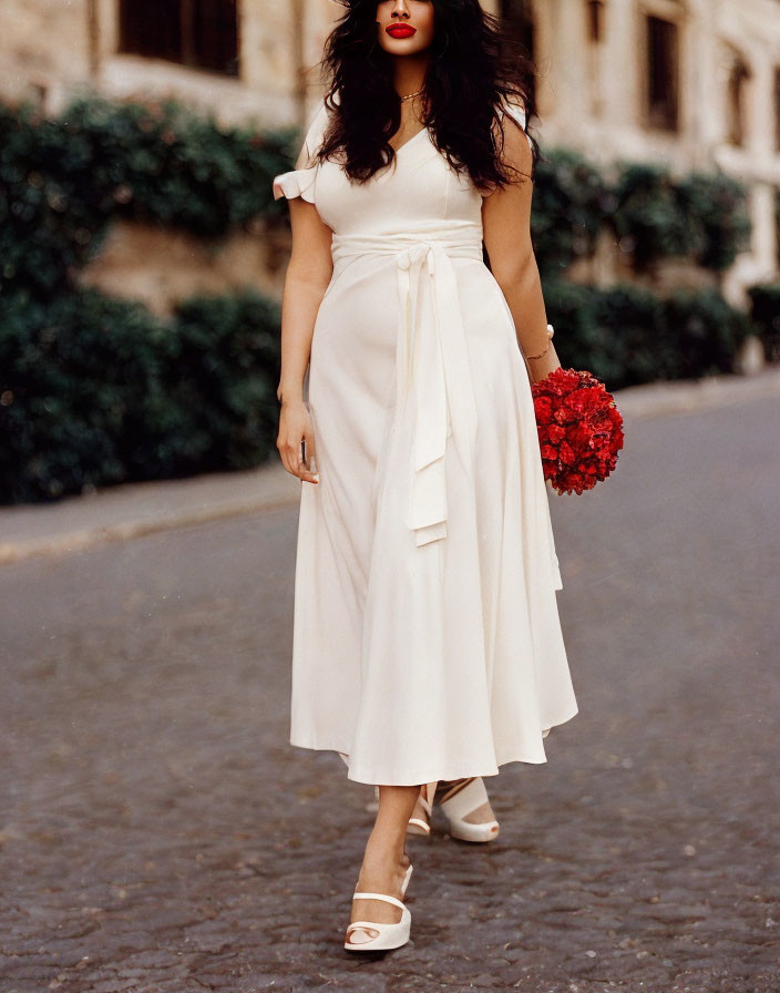 Stylish white midi dress with tied waist detail and red flower bouquet