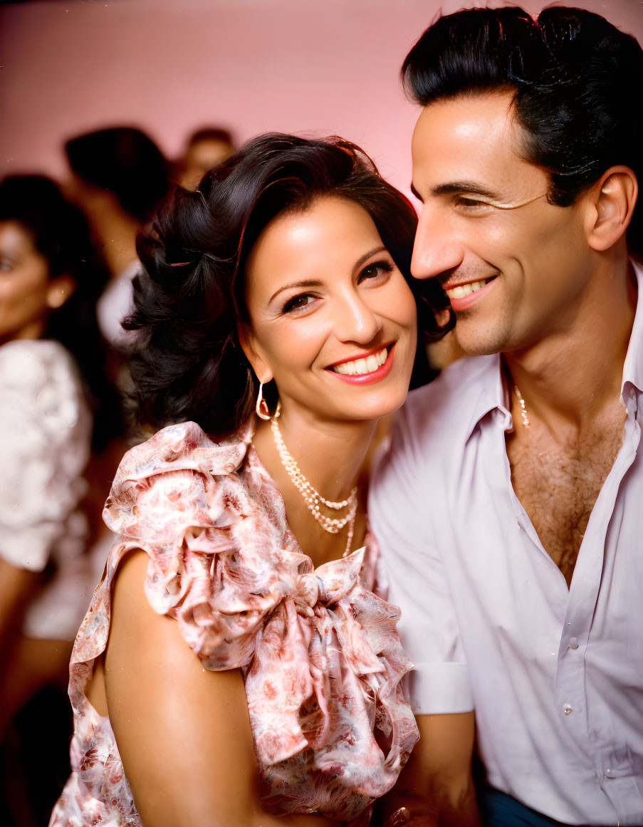 Stylish couple smiling at social event with lively background