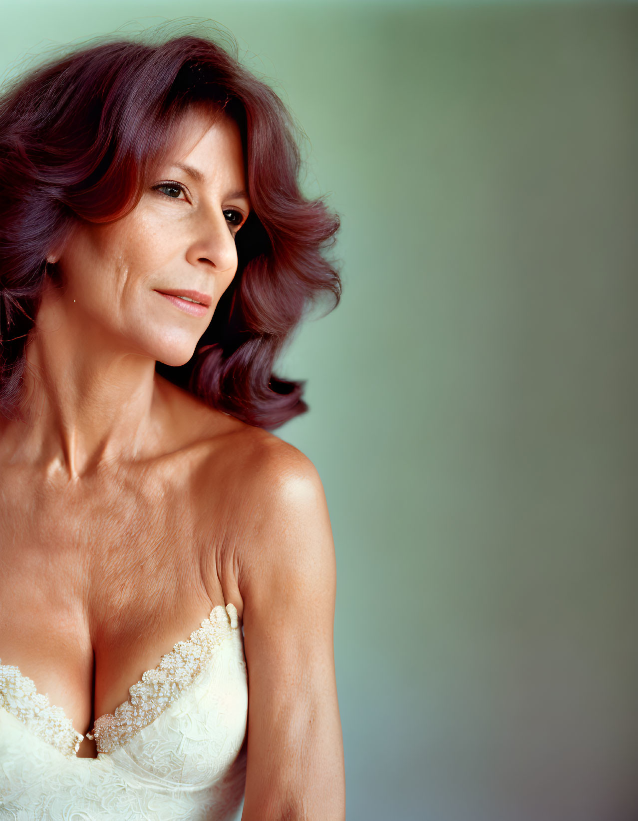 Smiling woman in white dress with chestnut hair